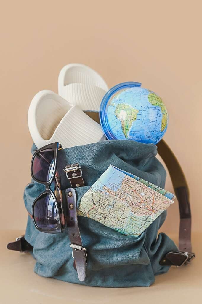 Trips. picking suitcase, things for tourism. Rest in a road trip. Tourism and travel accessories